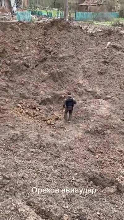 ua pov: Impact crater after Russian aviation bomb in Orechovo, Zaporozhie