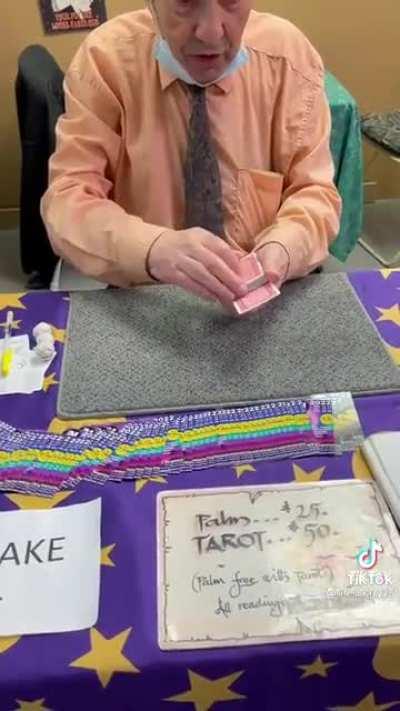 Magician showing off a deck of magic cards