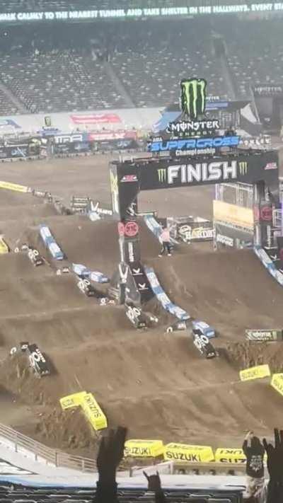 mad lad tosses his shirt and jumps onto the track