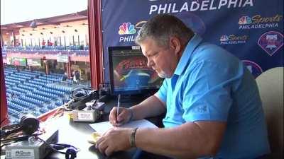 John Kruk eating a hog dog.