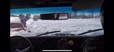 Race cars fall into frozen lake.