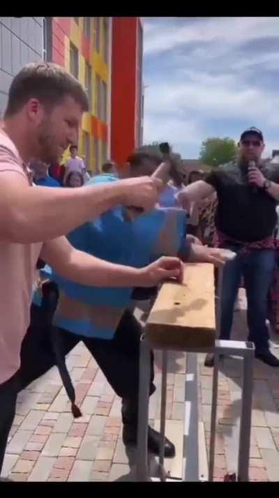 Strongman Dmitry Khaladzhi driving in a nail with his hand