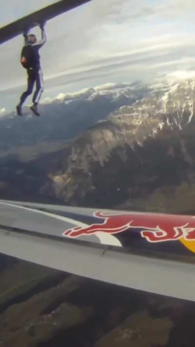 A skydiver transferring from one airplane wing to another while in midair
