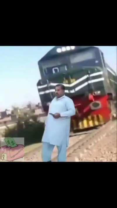 Man takes a selfie with a train
