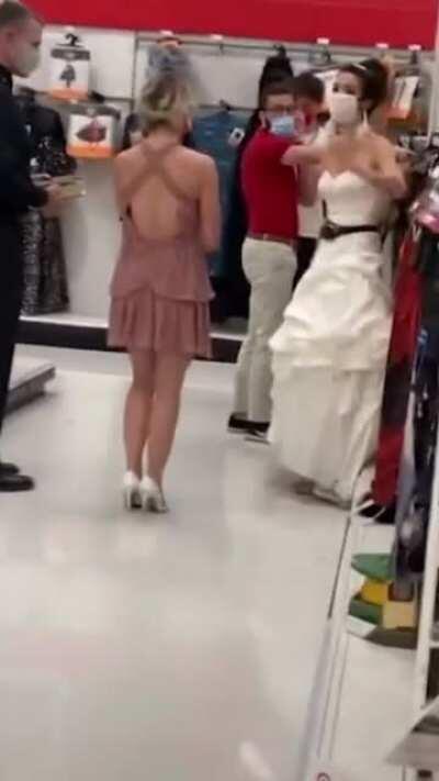 Woman in a wedding gown storms a Target store with a bridesmaid, bouquet, and pastor in tow: 