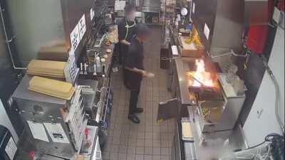 Grease fire starts in kitchen. Dudes just stare at it before throwing water on it.