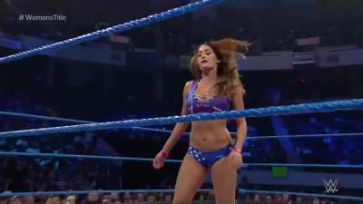 Nikki Bella tossing Carmella to the outside and standing above the SmackDown Women's Division