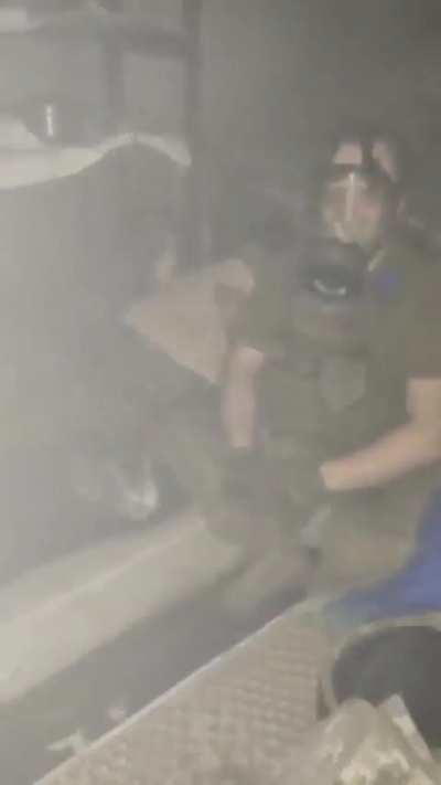 Ukrainian soldiers try to keep their cool in a basement as the building above them burns. A little cat can be seen taking cover with the crew. Godspeed. Unknown date 