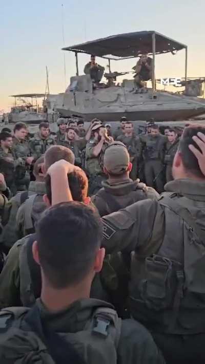 Israeli soldiers are seen gathering around ahead of an attack on Rafah, with a soldier rallying the troops and urging them to 