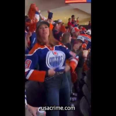 Edmonton Oilers fan flashing in the crowd.