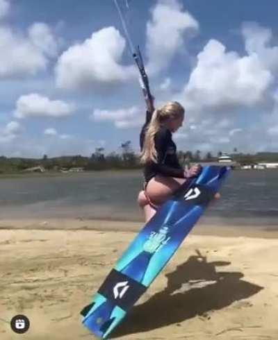 Woman performs a wakeboarding trick across land