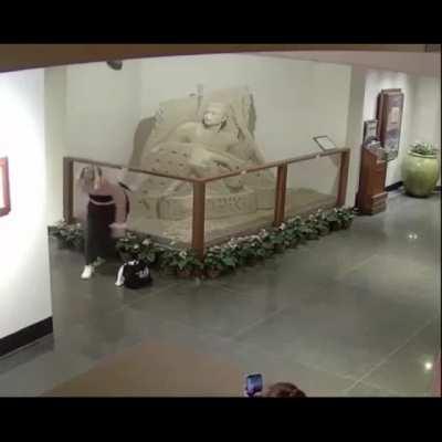 Girl destroys sand sculpture