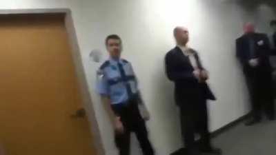 to push past armed courtroom guards