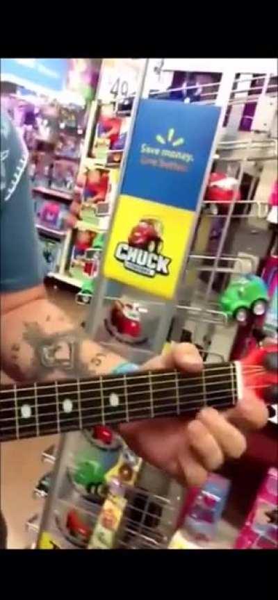 He uses a toy guitar to play this good and sings well