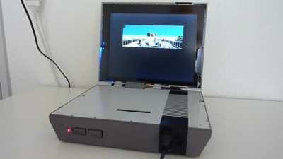NES console modded to be played on the go with a built in LCD screen. The games are running through original NES hardware and not an emulator in a shell