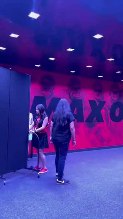 Taylor arriving at the Chiefs game behind a security barrier