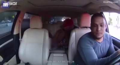 Taxi driver trying to keep his composure while lady having a baby at the back seat of his car