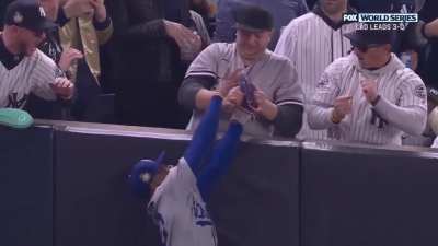 Yankees fans trying to rob Mookie Betts of his catch and his arm.