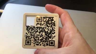 I printed a single-layer QR code onto the bed, and then a sliding puzzle design on top of that