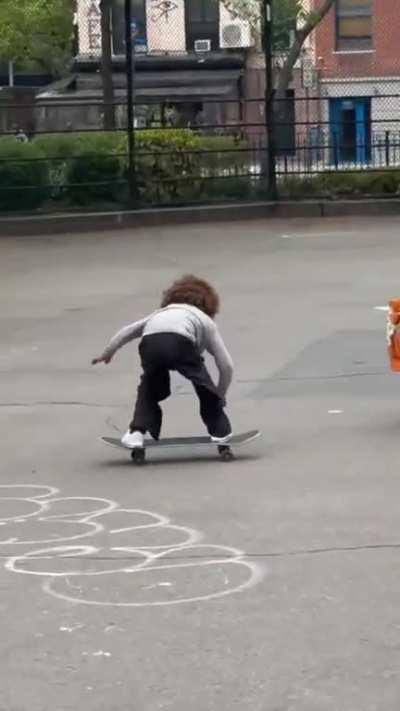 Helping kid skateboarding