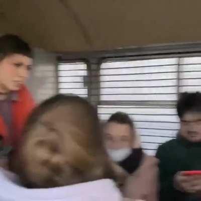 Russian protesters in a police car