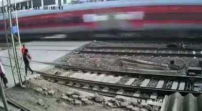 Rushing to cross the railroad tracks and nearly getting hit by a train