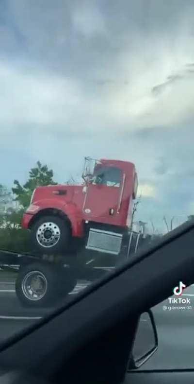 Hold my beer while I drive a truck carrying a truck carrying a truck carrying a truck