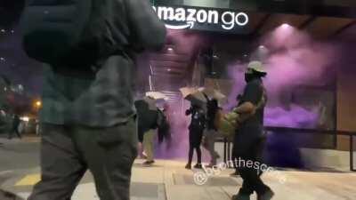Antifa peacefully smashing the glass at a Seattle Amazon Go store