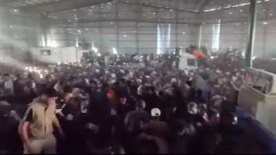 Chaos Inside a UNRWA warehouse in Deir al-Balah, Gaza as thousands of hungry people push and shout clawing for sacks of flour and child nutrition boxes that were hidden