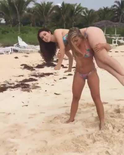 Katarina Konow squats her friend on the beach