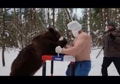 Russian guys armwrestle a bear