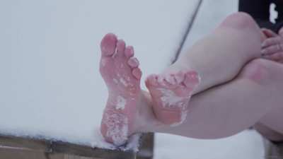 Hot girl barefoot in the cold snow