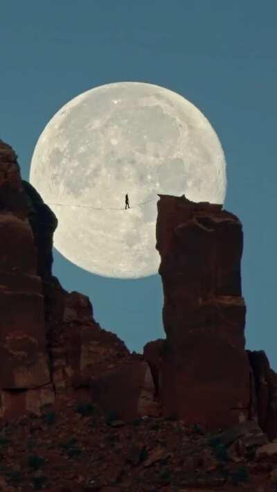 After months of effort, adventure photographer Renan Ozturk lined up this shot of high-line artist Andy Lewis walking between two desert towers outside Moab, Utah.