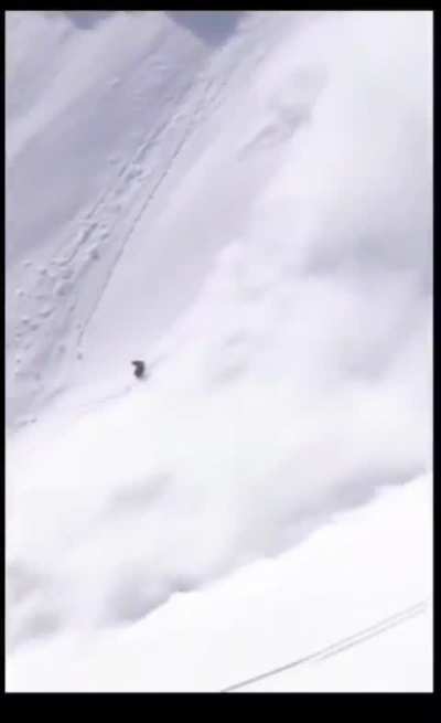 Guy outrunning an avalanche does a backflip