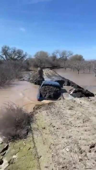 Two trucks to stop a flood?...or since we're at it, build a bridge?