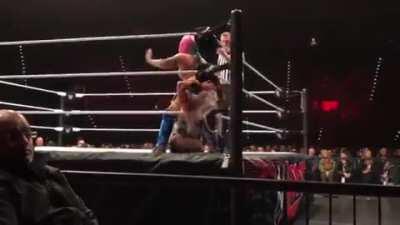 Asuka With a Stinkface to Dana Brooke.