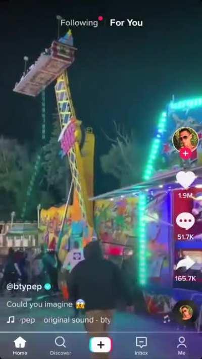 This carnival ride starting to topple over while people are riding it.