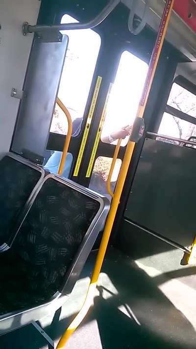 A guy smashes out a bus door window and threatens the rider inside