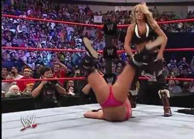 Trish strips Victoria to her bra and panties exposing her fat ass to the crowd.