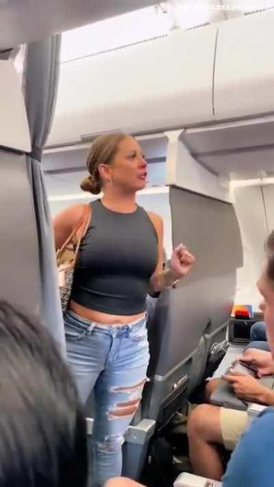 A passenger of this viral video is stating that this female believes she was sitting next to some sort of âreptilian manâ in a green hoodie on this plane. Male passenger that was sitting 3 rows behind the incident claims that the man in the green hood