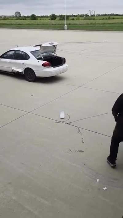 Salt and pepper crew steal tire off truck while person is in the back.