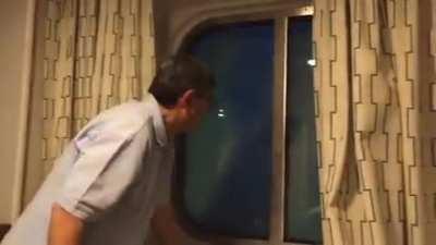 casual grandpa watches his cabin window submerge