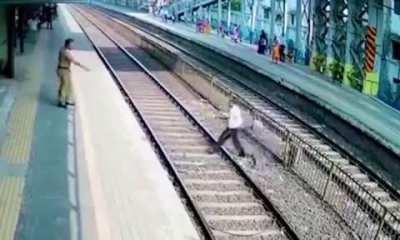 Crossing a train track gets a slap from cop and almost looses his life