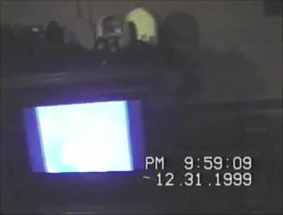 Guy shows off his new $5,000 TV to friends at a Y2K New Year's Eve Party