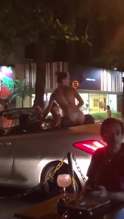 Throwing trash at a woman in a bikini