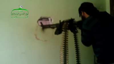 Opposition fighter uses a DShK indoors to target Syrian Army controlled buildings - al-Rashidin District, Aleppo - 12/28/2013