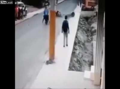 Asshole kid causes a pair on a motorcycle to crash