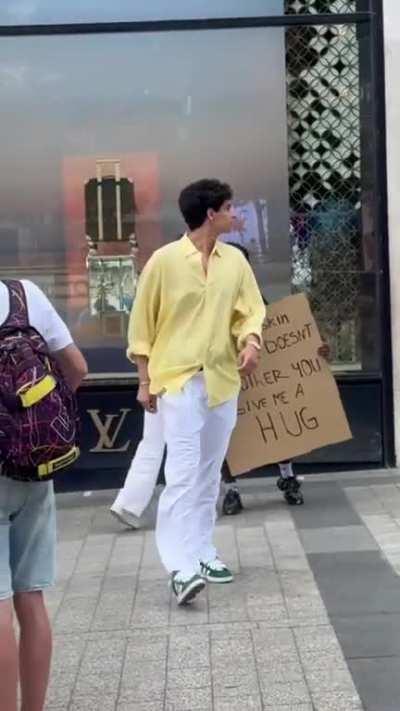 Hug me or you're racist. Nevermind the fact that covid still exists.