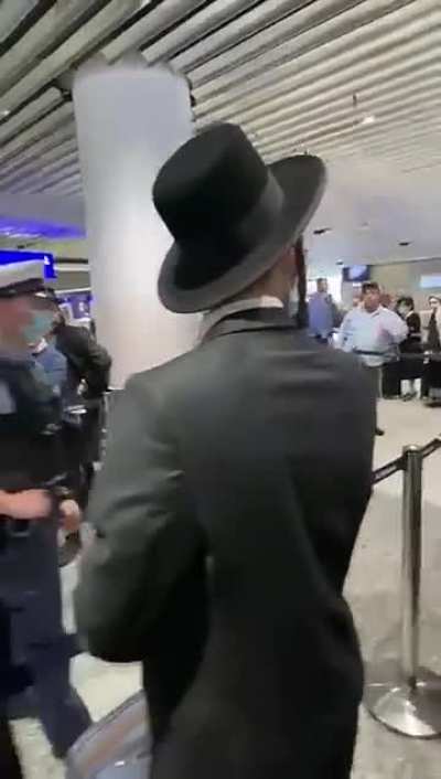 German Policeman reacts to being called a Nazi at an airport gate by the expected group 