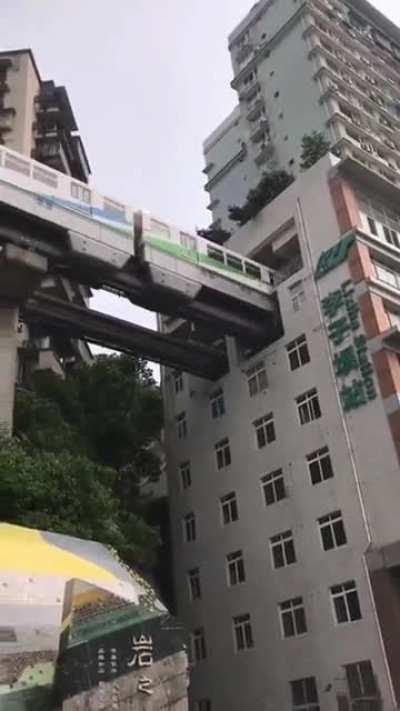 Wait for it... The train passes a 19-story apartment block in Chongqing, China. 😄😃🥰🤩😍